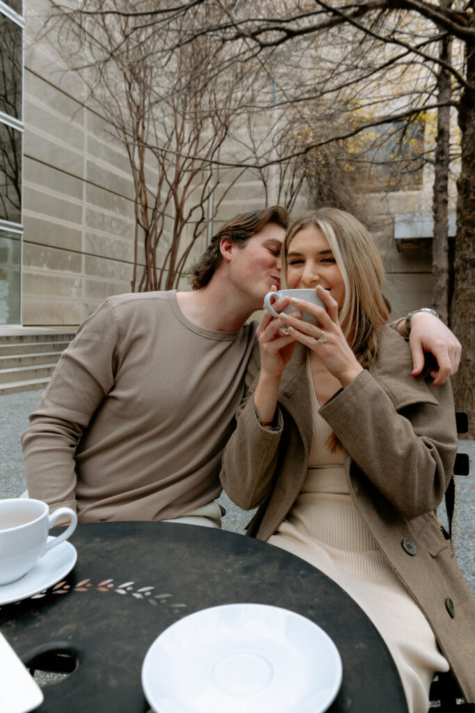 Photo of engaged couple sipping coffee