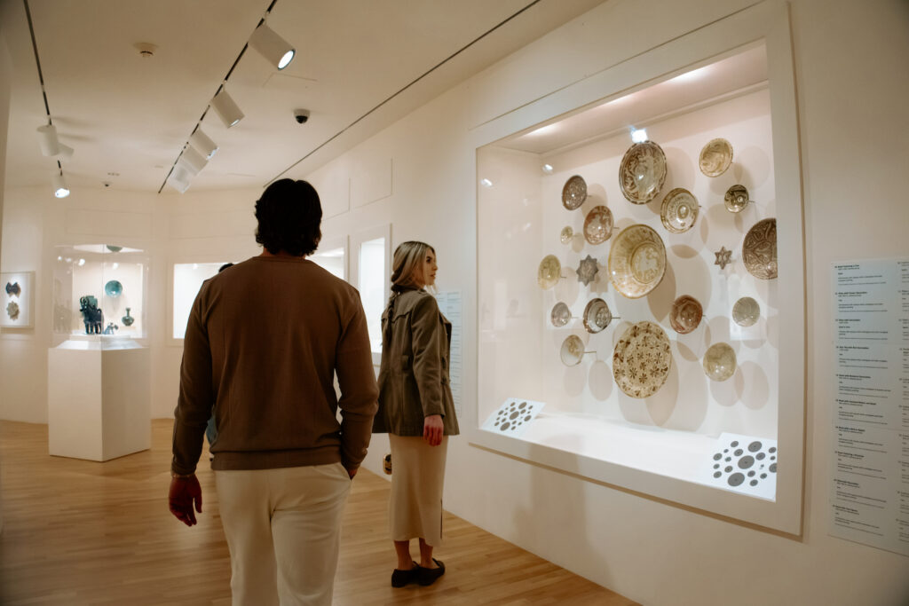 A man and a woman admiring art in a museum