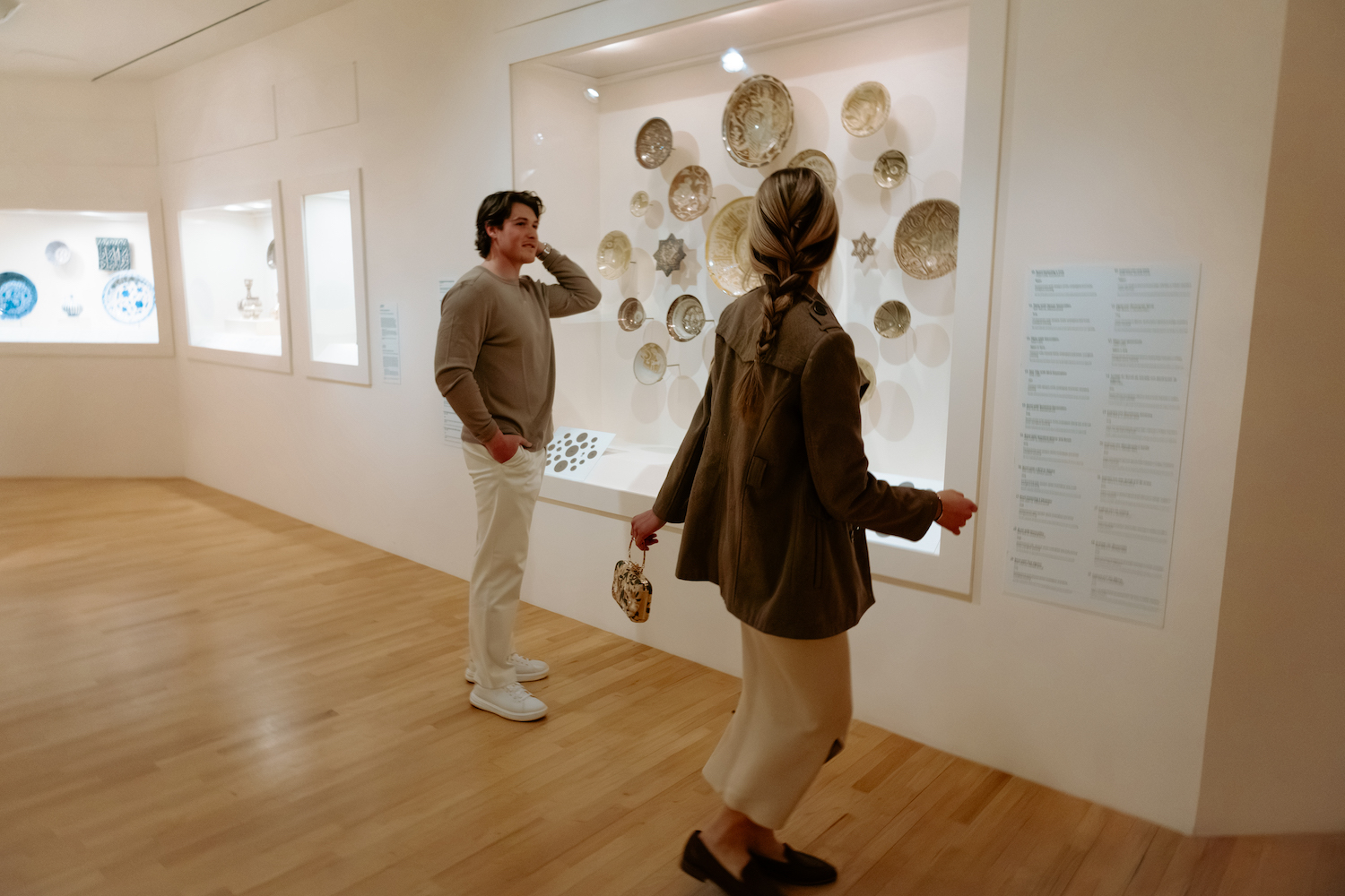 A man and a woman in a museum admiring the art